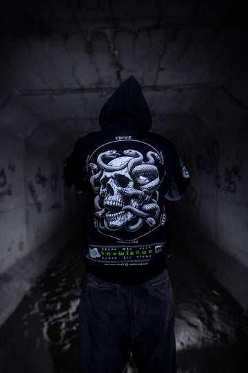 Male model back view wearing the Dark Matter Threads Knowledge black unisex hoodie with the hood up and back graphic design.